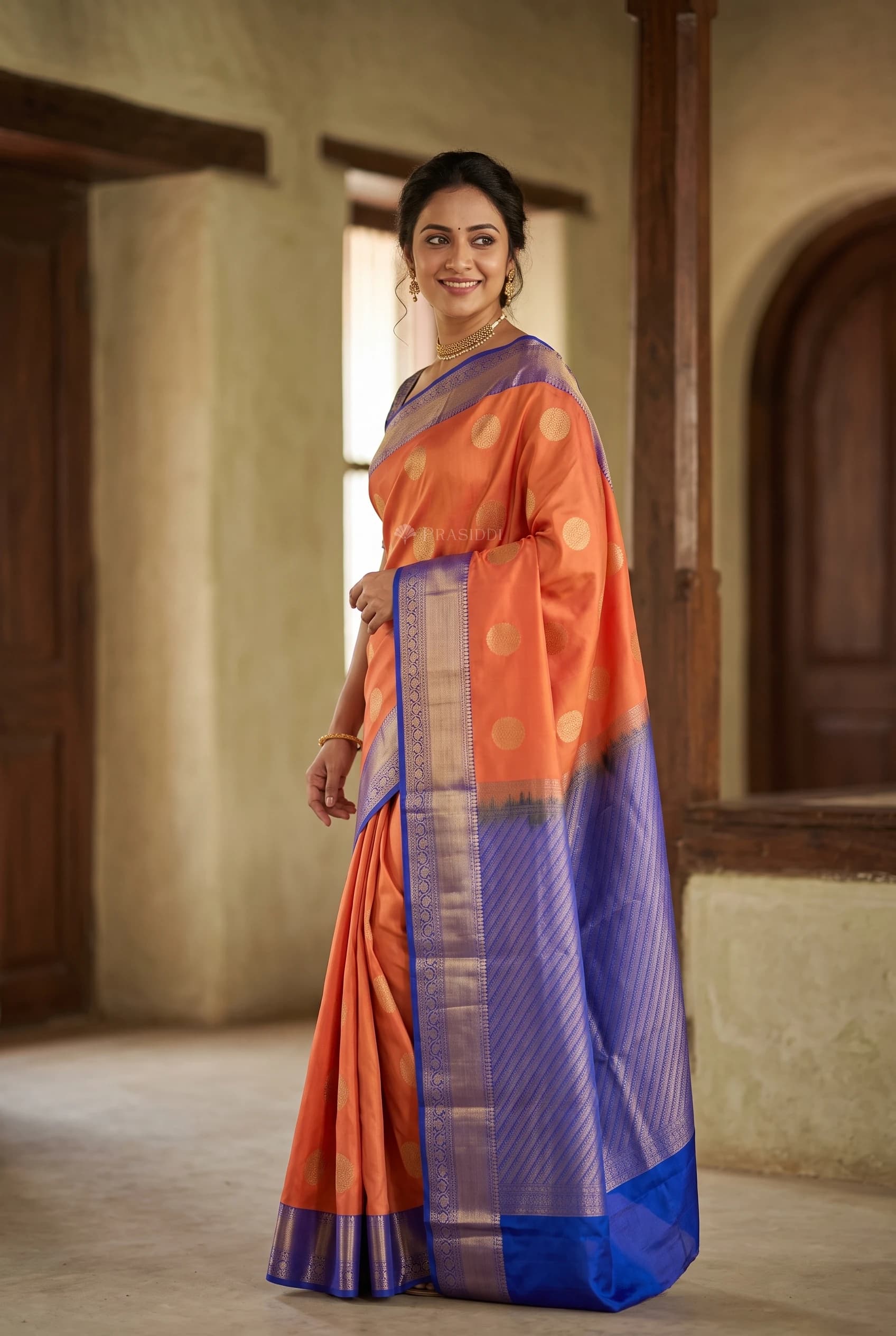 Orange and Bright Blue Traditional Silk Saree with Woven Zari Border – Model Displaying Full Saree