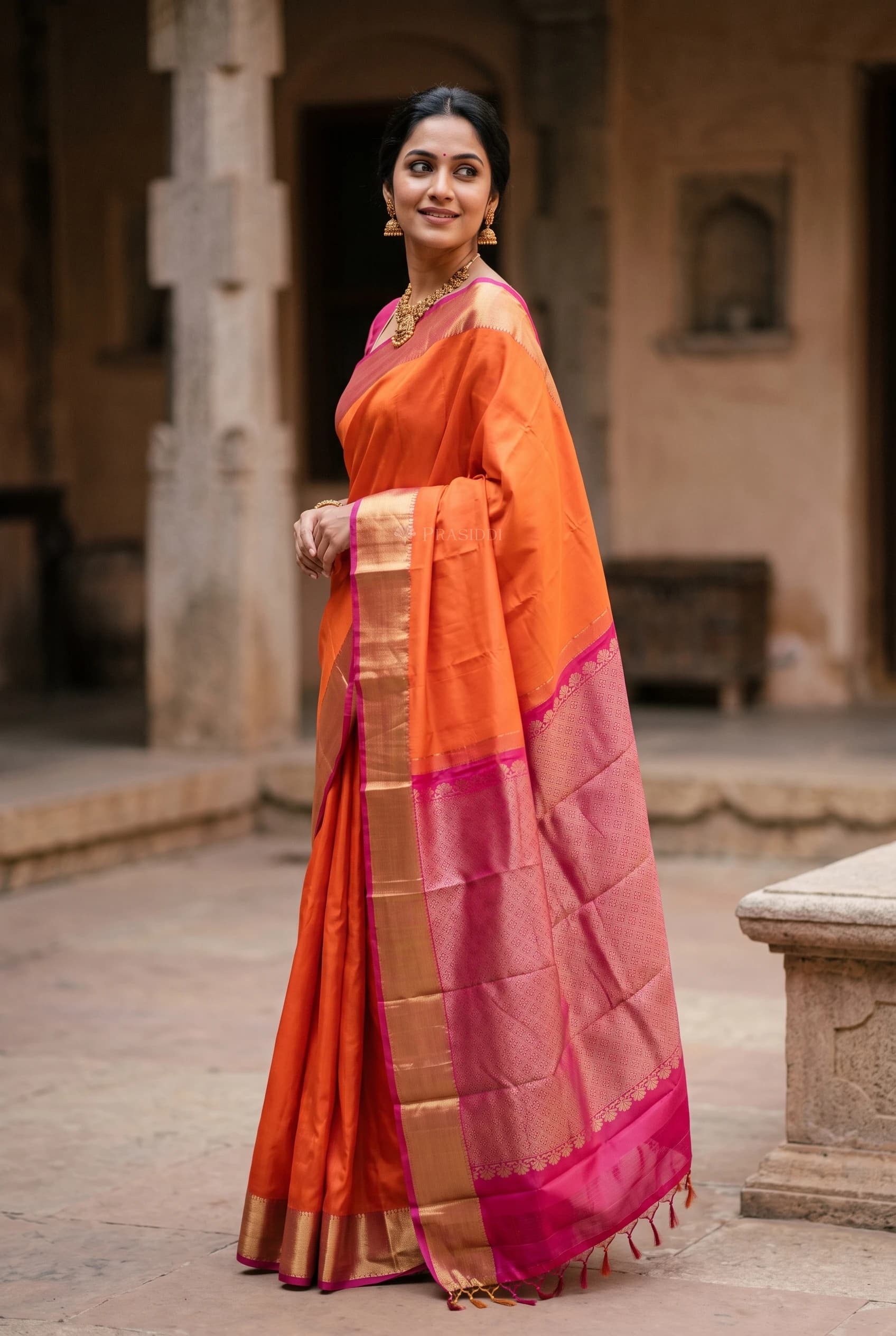 Orange and Light Pink Silk Saree with a Contrast Border and Grand Pallu. – Model Displaying Full Saree